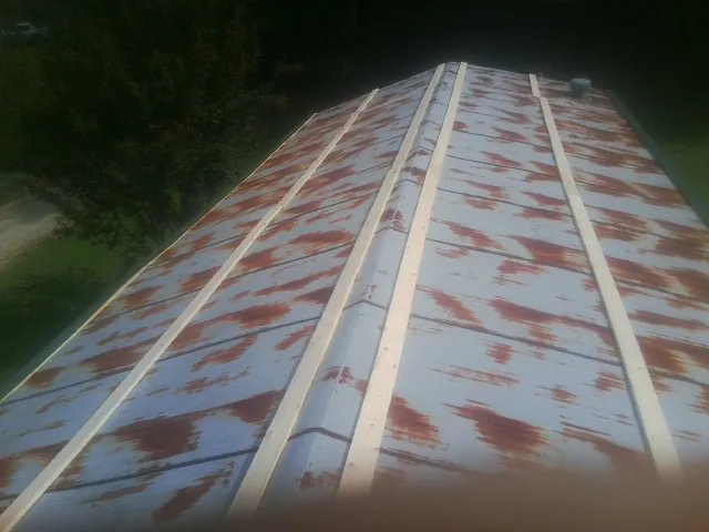 Rusted metal roof panels with new wood purlins before replacement — Storm Damage Roof Repair in Coplay by Roofing Brothers