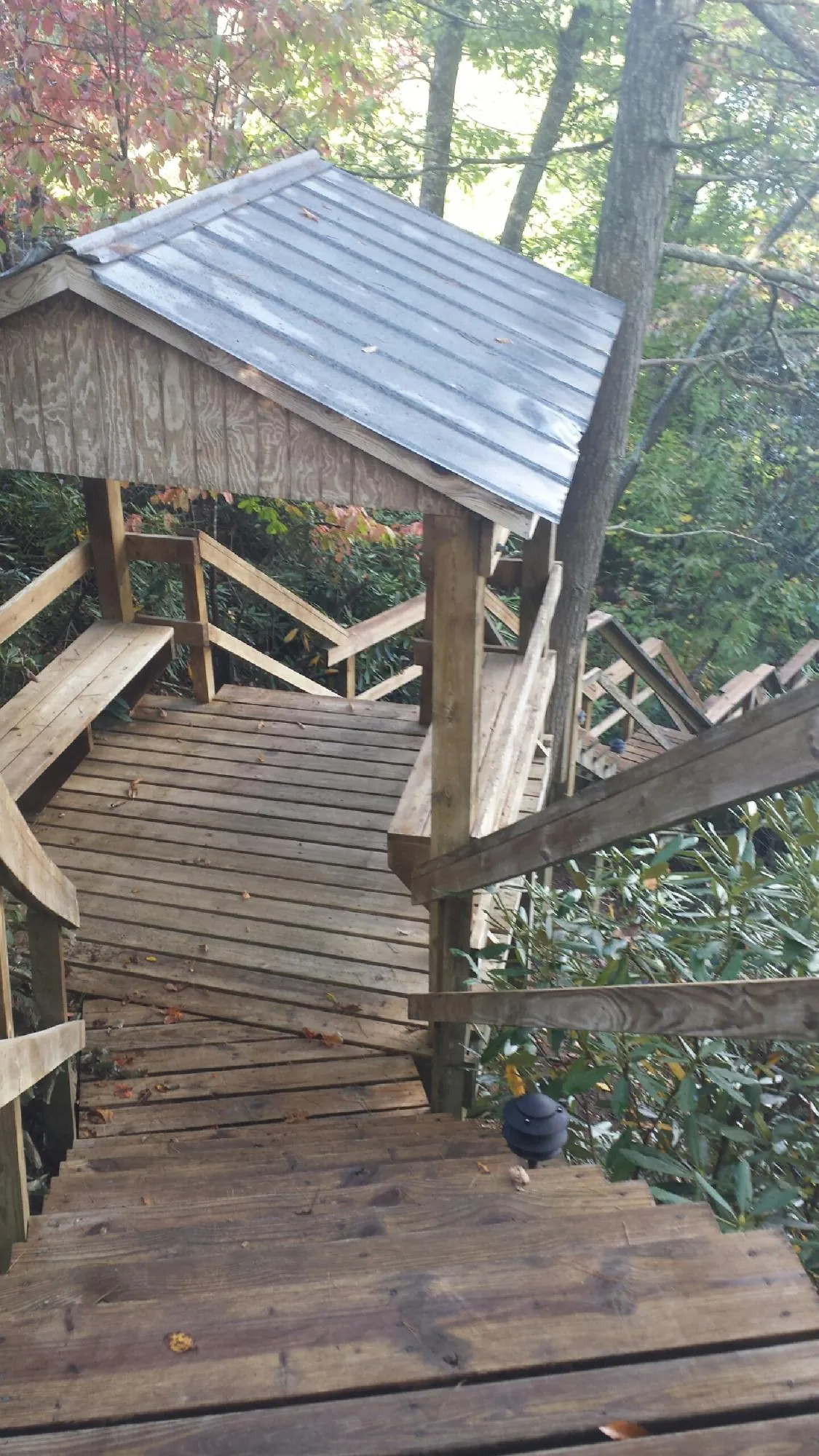 Metal roofed shelter over wooden steps on a wooded walkway — Skylight Repair & Installation work by our crew in Coplay