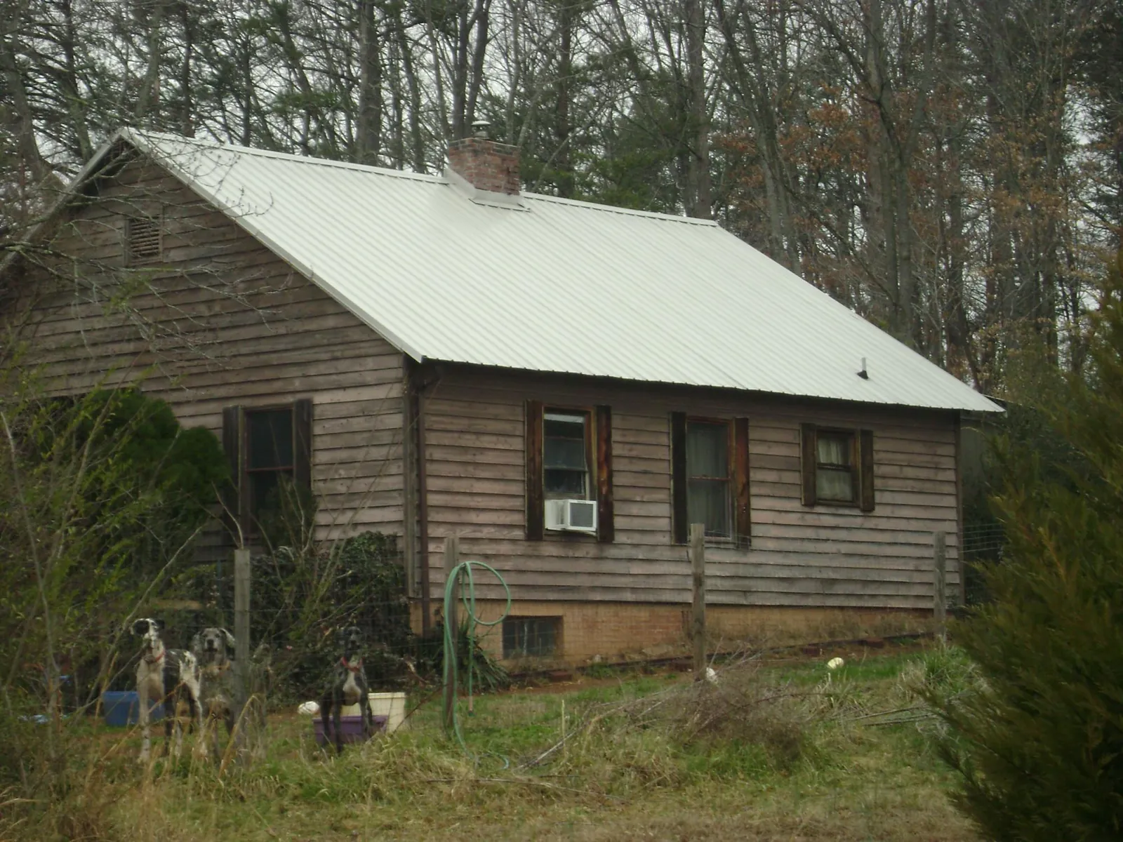 White metal roof on an old wood sided farmhouse, from a Asphalt Shingle Roof Repair job in Coplay